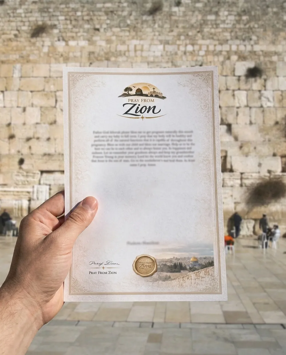 A Pray From Zion prayer held up at the Western Wall